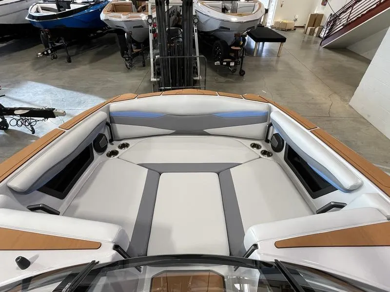 Slide: The Image of 2025 Axis A225 boat interior with spacious seating and modern design in showroom. - 19