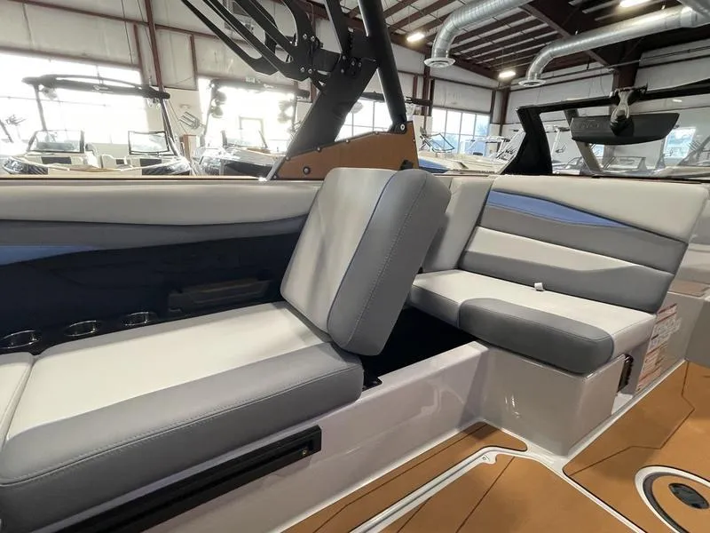 Slide: The Image of Interior of 2025 Axis A225 boat with modern seating in a showroom. - 21