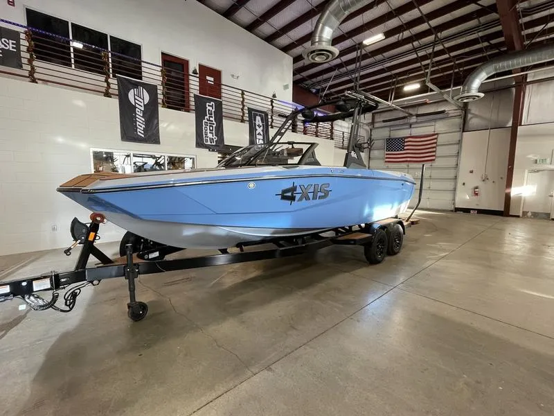 Slide: The Image of 2025 Axis A225 boat in a showroom with American flag. - 3