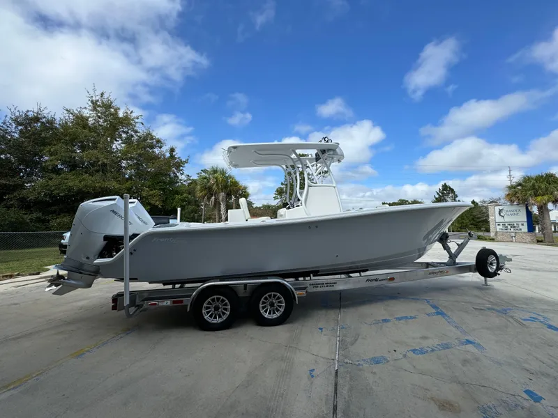 Slide: The Image of 2024 Front Runner 26 Center Console boat on trailer under blue sky. - 11