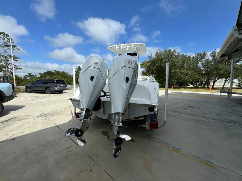 Slide: The Image of 2024 Front Runner 26 Center Console boat with dual outboard motors on a trailer. - 14