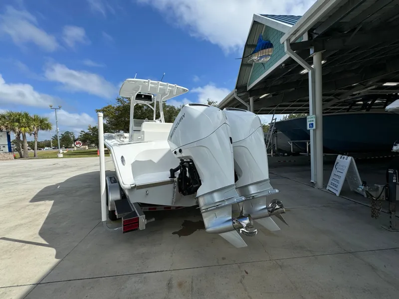 Slide: The Image of 2024 Front Runner 26 Center Console boat with dual engines at a marina. - 16