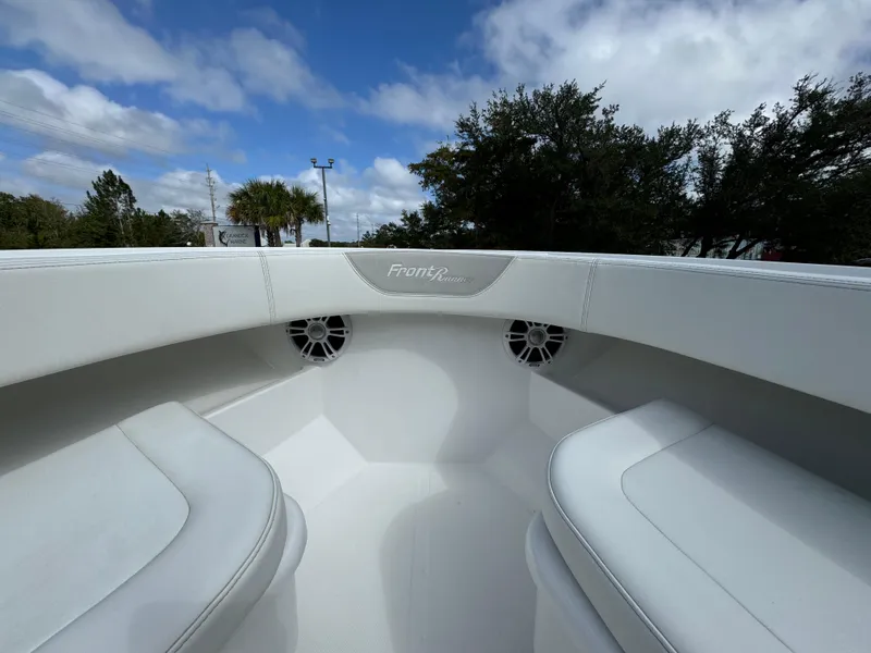 Slide: The Image of 2024 Front Runner 26 Center Console boat interior with white seating and speakers. - 18
