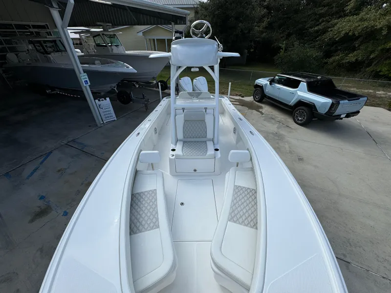 Slide: The Image of 2024 Front Runner 26 Center Console boat with sleek design, parked near a modern vehicle. - 20
