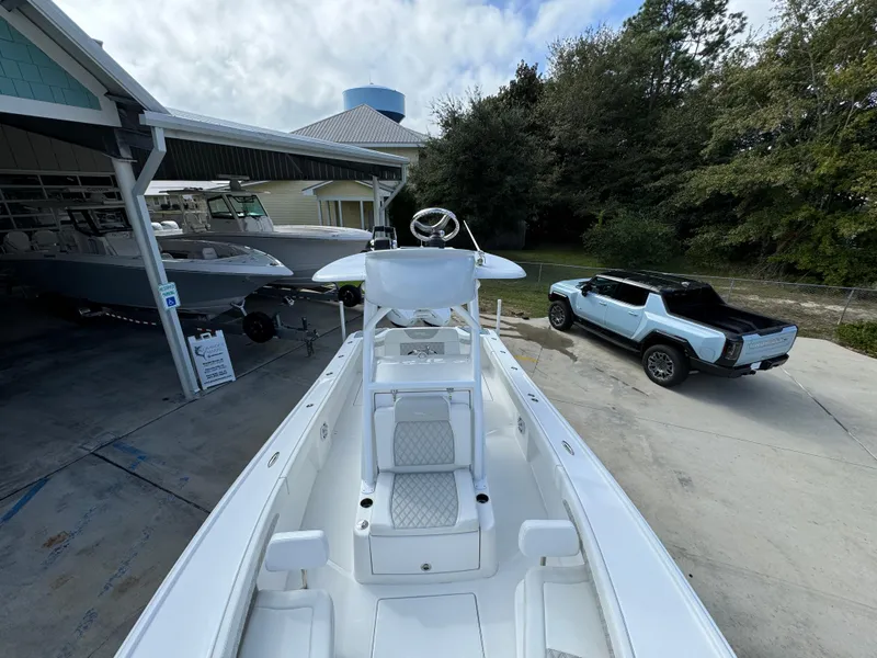 Slide: The Image of 2024 Front Runner 26 Center Console boat at a dealership with a truck nearby. - 21