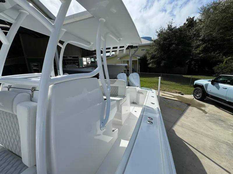 Slide: The Image of 2024 Front Runner 26 Center Console boat, sleek design, parked outdoors. - 25