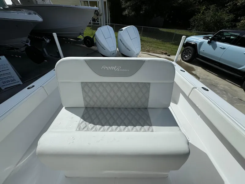 Slide: The Image of 2024 Front Runner 26 Center Console boat with dual engines and cushioned seating. - 28