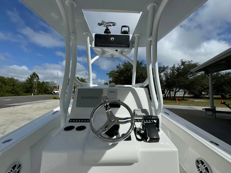 Slide: The Image of 2024 Front Runner 26 Center Console boat with Garmin navigation system and sleek steering wheel. - 31