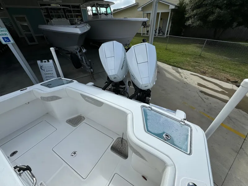 Slide: The Image of 2024 Front Runner 26 Center Console boat with dual engines, parked outdoors. - 34
