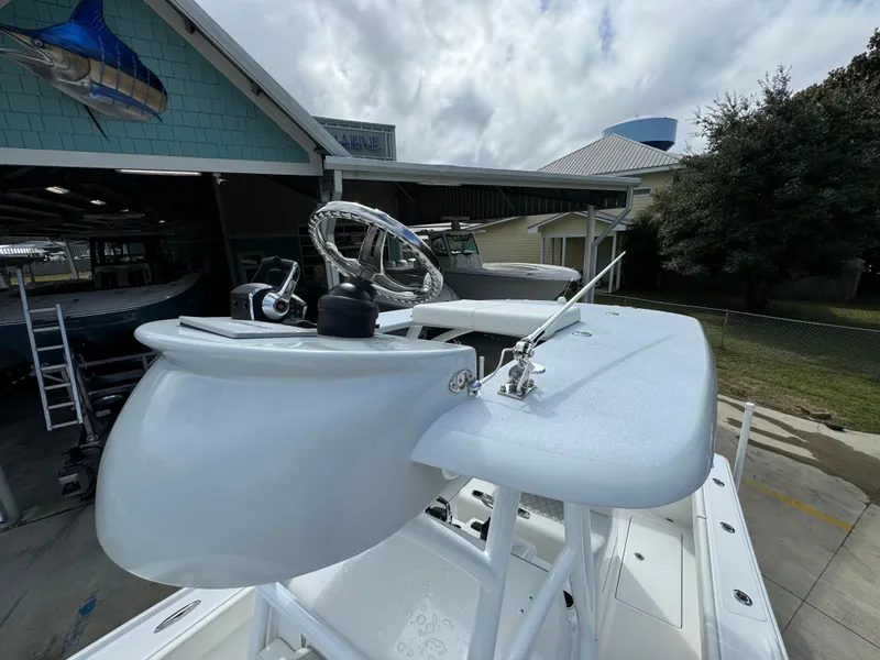 Slide: The Image of 2024 Front Runner 26 Center Console boat at a marina under cloudy skies. - 37
