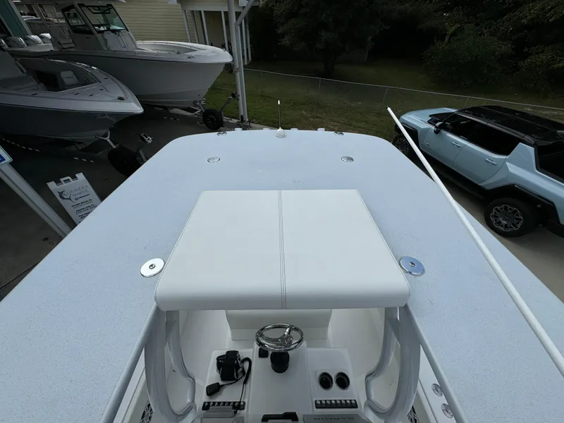 Slide: The Image of 2024 Front Runner 26 Center Console boat, top view, parked near vehicles. - 41