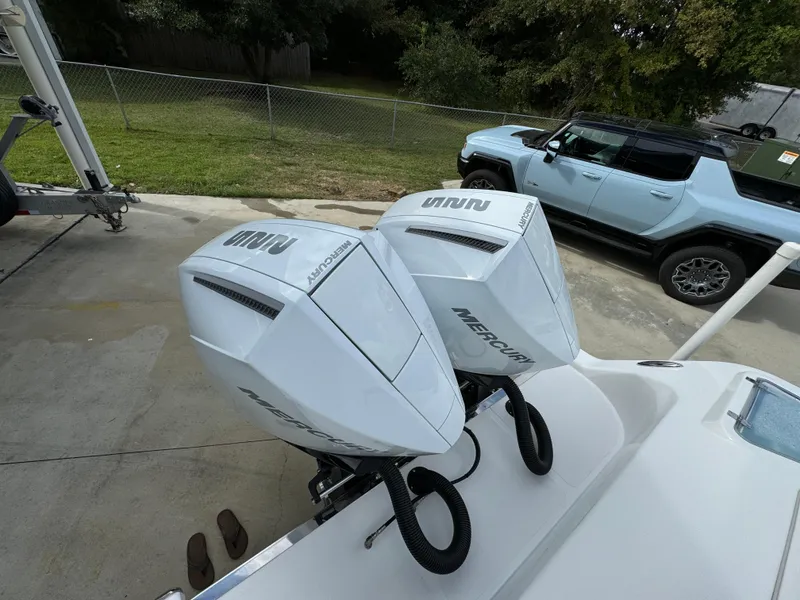 Slide: The Image of 2024 Front Runner 26 Center Console with dual Mercury outboard engines in a driveway. - 43