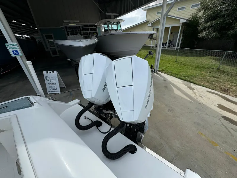 Slide: The Image of 2024 Front Runner 26 Center Console with twin outboard engines in a boatyard. - 44