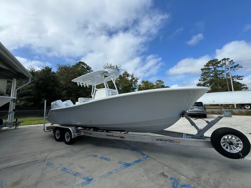 Slide: The Image of 2024 Front Runner 26 Center Console boat on trailer, parked outdoors under blue sky. - 9