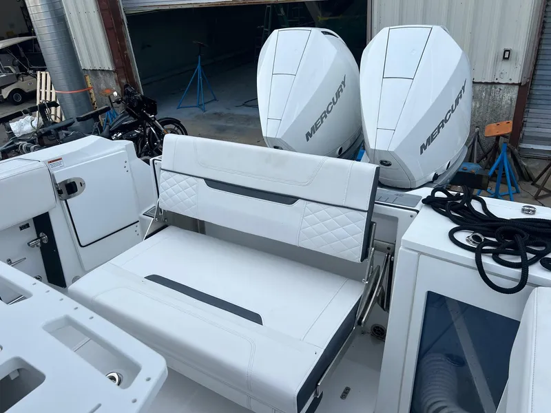 Slide: The Image of 2023 Blackfin 272 CC boat with dual Mercury engines and white seating. - 11