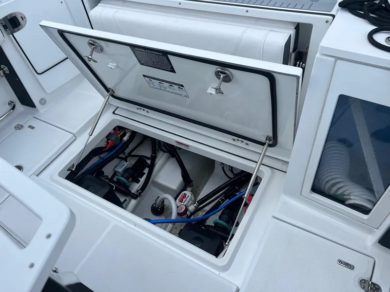 Slide: The Image of Open hatch of 2023 Blackfin 272 CC boat showing internal components and wiring. - 12