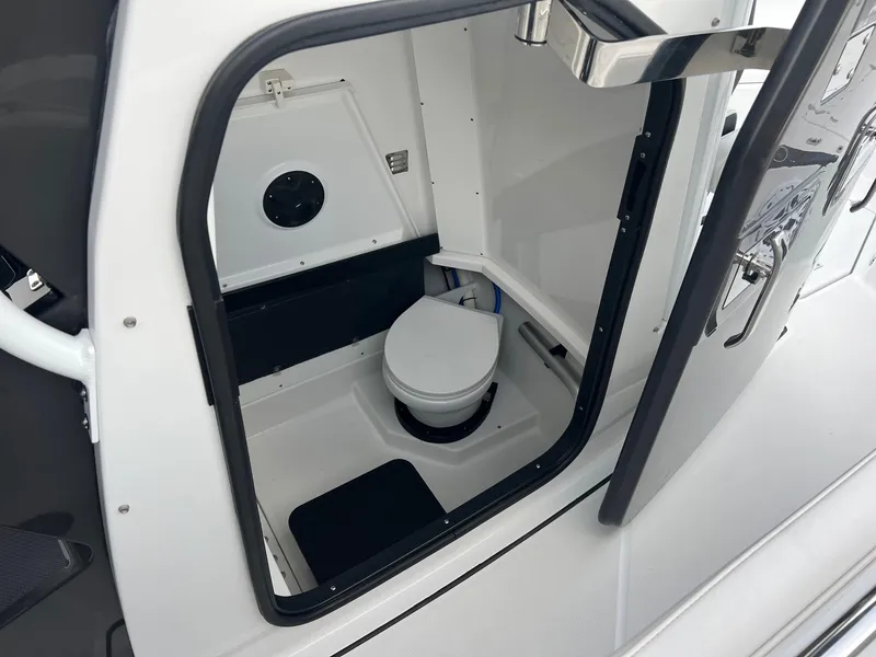 Slide: The Image of 2023 Blackfin 272 CC boat interior with compact marine toilet. - 14