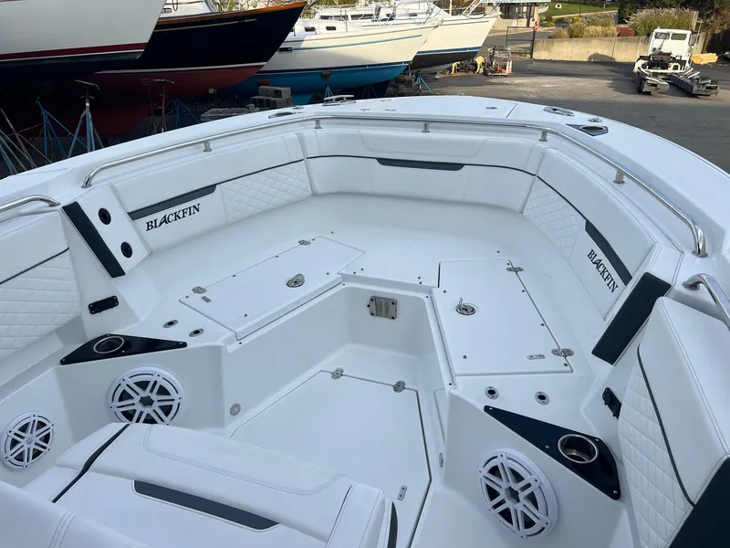 Slide: The Image of 2023 Blackfin 272 CC boat interior with white seating and speakers. - 16
