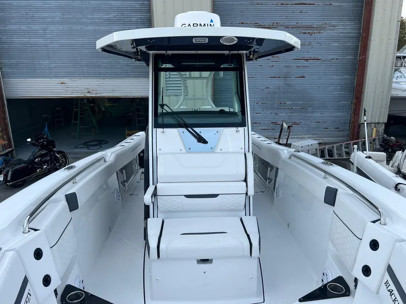 Slide: The Image of 2023 Blackfin 272 CC boat with sleek white interior and advanced navigation equipment. - 19
