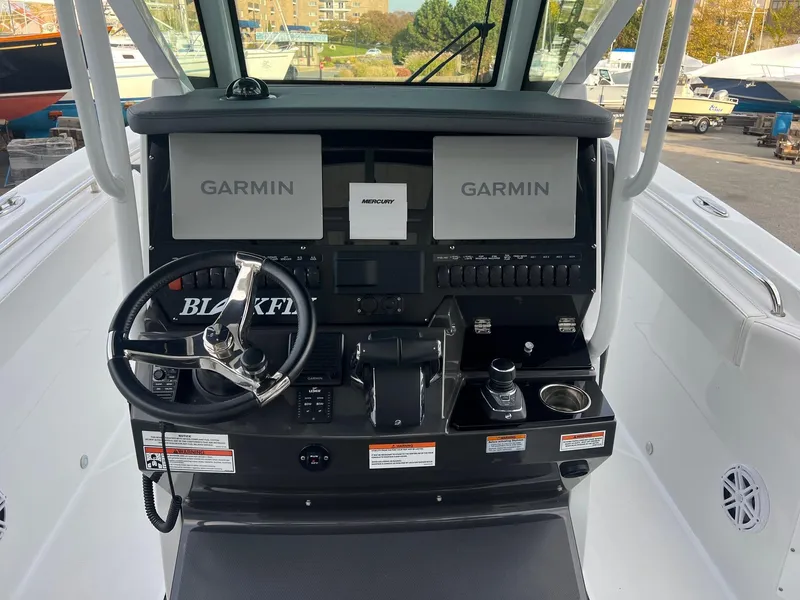 Slide: The Image of 2023 Blackfin 272 CC boat dashboard with Garmin navigation displays. - 7