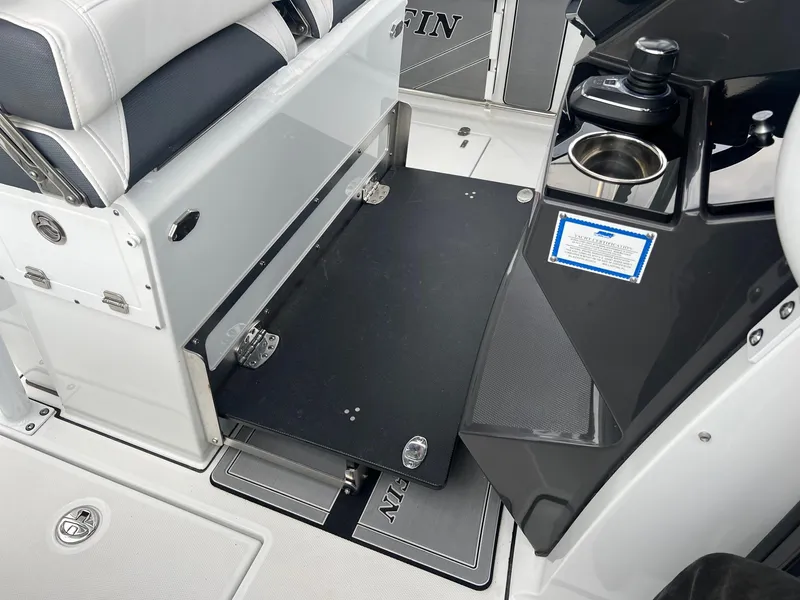 Slide: The Image of 2023 Blackfin 272 CC boat interior with fold-out seat and console details. - 9