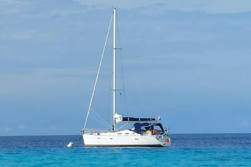 The Image of Sailboat Beneteau Oceanis 393, 2001 model, anchored in clear blue sea. - 0