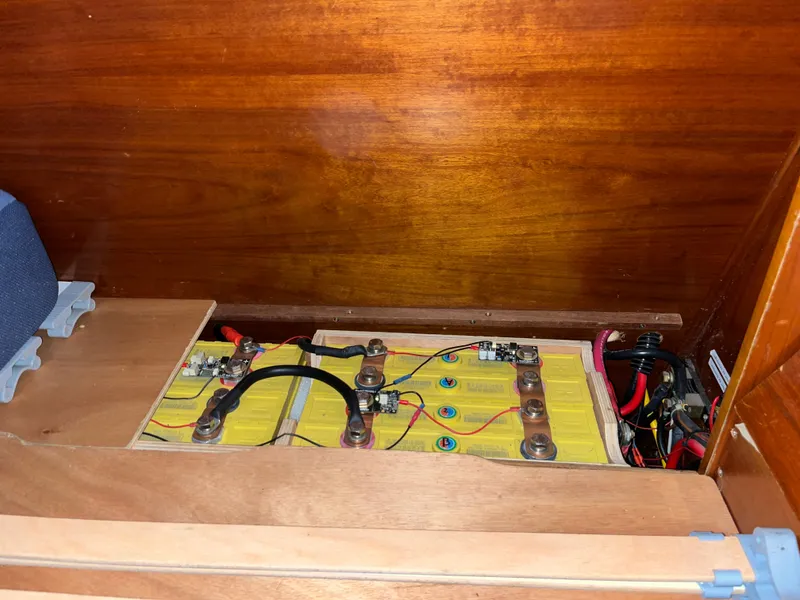 Slide: The Image of Battery compartment of a 2001 Beneteau Oceanis 393 sailboat, showcasing wiring and connections. - 11