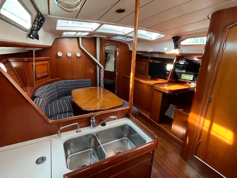 Slide: The Image of Interior of 2001 Beneteau Oceanis 393 sailboat with wood finish and modern amenities. - 18