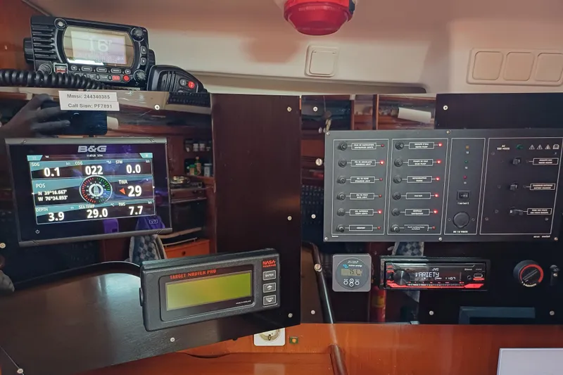 Slide: The Image of Control panel of a 2001 Beneteau Oceanis 393 sailboat with navigation and communication equipment. - 21