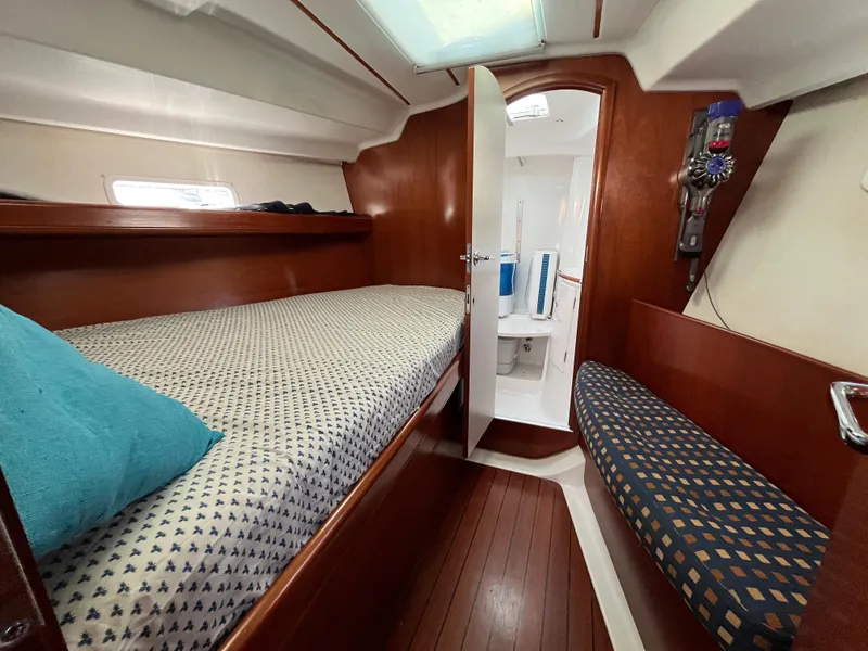 Slide: The Image of Cozy cabin interior of 2001 Beneteau Oceanis 393 sailboat with wooden finishes and comfortable bedding. - 25