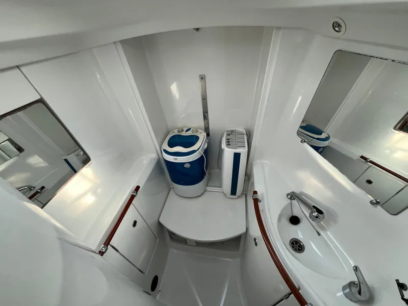 Slide: The Image of Beneteau Oceanis 393 bathroom, 2001 model, featuring compact design with sink and storage. - 26