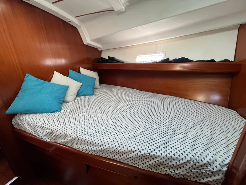 Slide: The Image of Cozy cabin interior of 2001 Beneteau Oceanis 393 with comfortable bedding and pillows. - 27