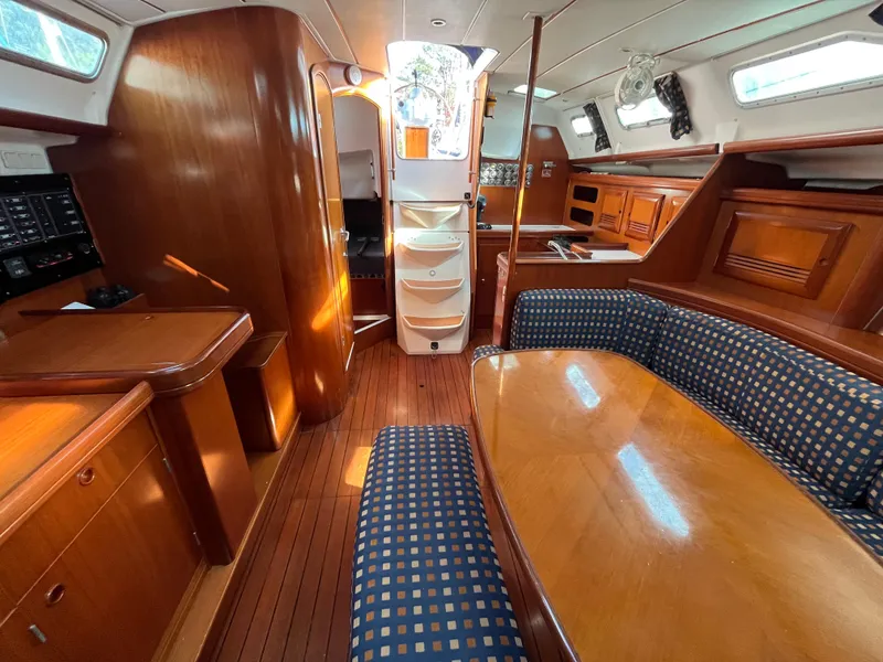 Slide: The Image of Interior of 2001 Beneteau Oceanis 393 sailboat with wooden furnishings and blue upholstery. - 29