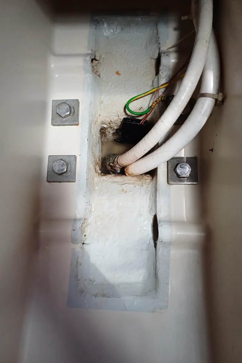 Slide: The Image of Interior view of a 2001 Beneteau Oceanis 393 sailboat showing wiring and bolts. - 31