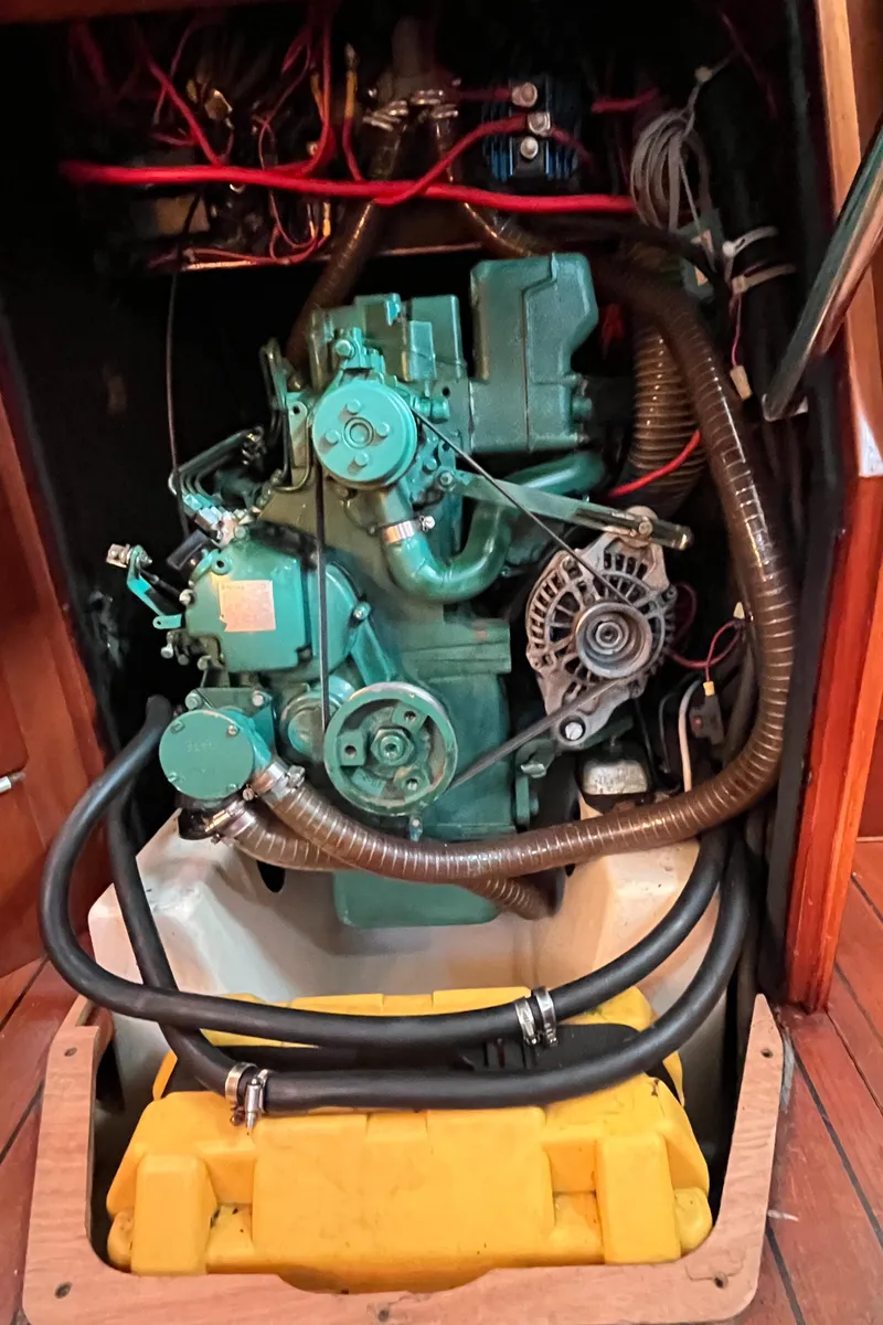 Slide: The Image of Engine compartment of a 2001 Beneteau Oceanis 393 sailboat, showcasing mechanical components and wiring. - 33