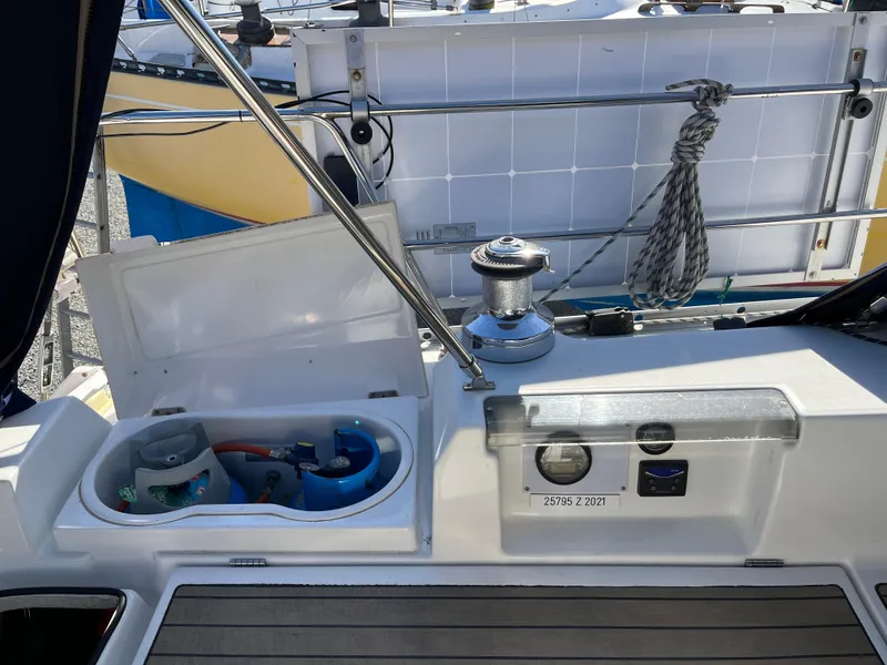 Slide: The Image of Beneteau Oceanis 393 sailboat deck, featuring winch and storage compartments, 2001 model. - 38