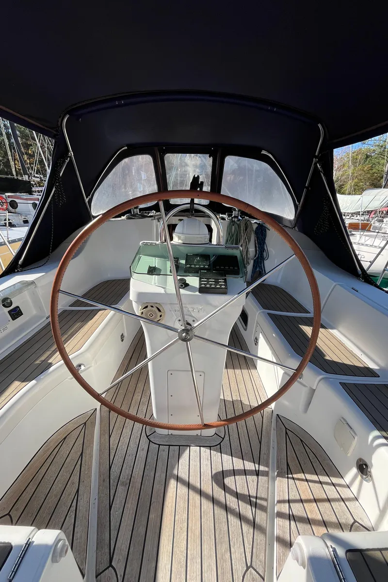 Slide: The Image of 2001 Beneteau Oceanis 393 sailboat cockpit with wooden wheel and sleek design. - 42