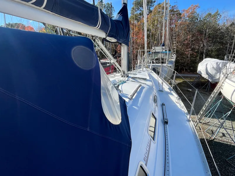 Slide: The Image of 2001 Beneteau Oceanis 393 sailboat with blue cover, docked in a marina. - 44