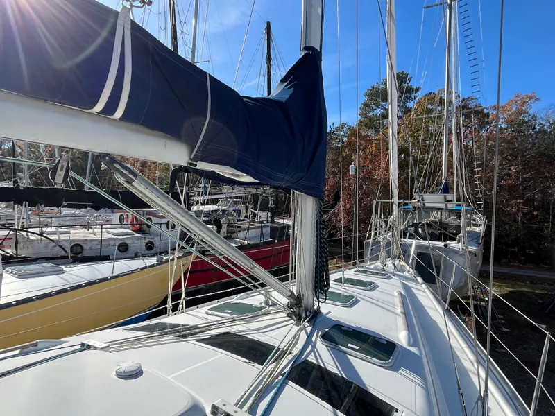 Slide: The Image of 2001 Beneteau Oceanis 393 sailboat docked, showcasing deck and rigging under clear blue sky. - 45
