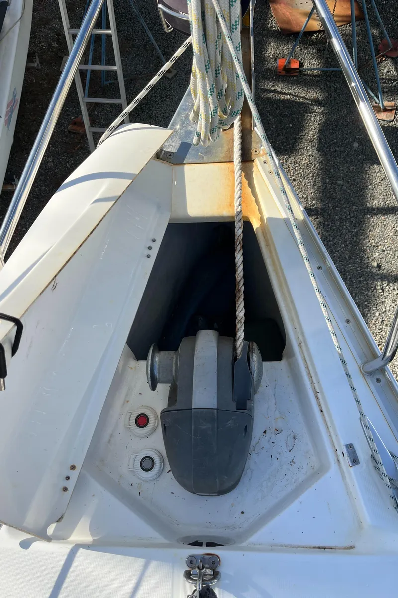 Slide: The Image of Beneteau Oceanis 393 sailboat anchor locker, 2001 model, with visible winch and rope. - 47