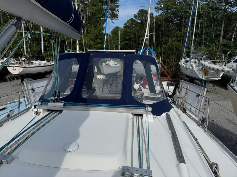 Slide: The Image of Beneteau Oceanis 393 sailboat, 2001 model, docked with blue canopy and visible rigging. - 49