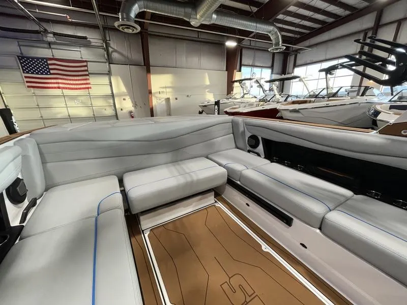 Slide: The Image of Interior of 2025 Axis A225 boat with gray seating in a showroom. - 17