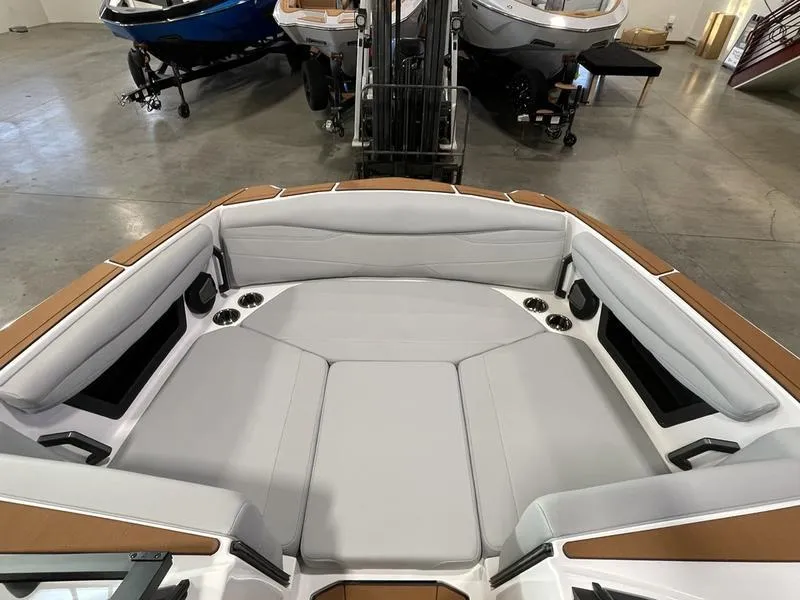 Slide: The Image of 2025 Axis A225 boat interior with spacious seating and modern design in a showroom. - 20