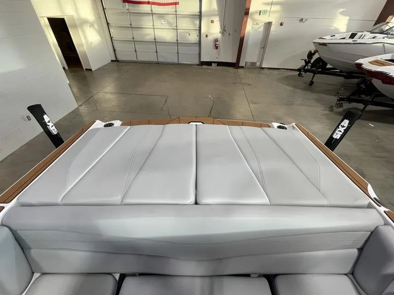 Slide: The Image of 2025 Axis A225 boat interior with sleek gray upholstery in a spacious showroom. - 24