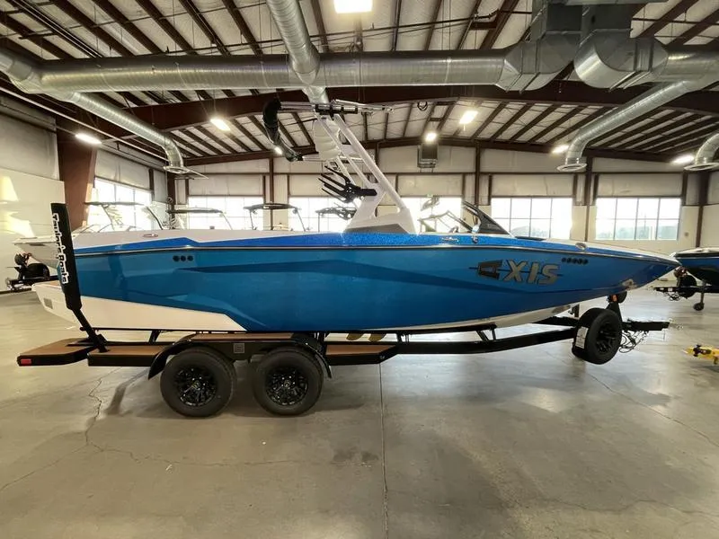 Slide: The Image of 2025 Axis A225 boat in a warehouse, blue exterior, on a trailer. - 5