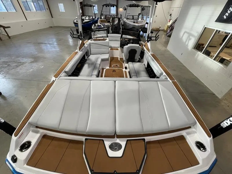 Slide: The Image of 2025 Axis A225 boat interior with spacious seating and modern design in a showroom. - 9