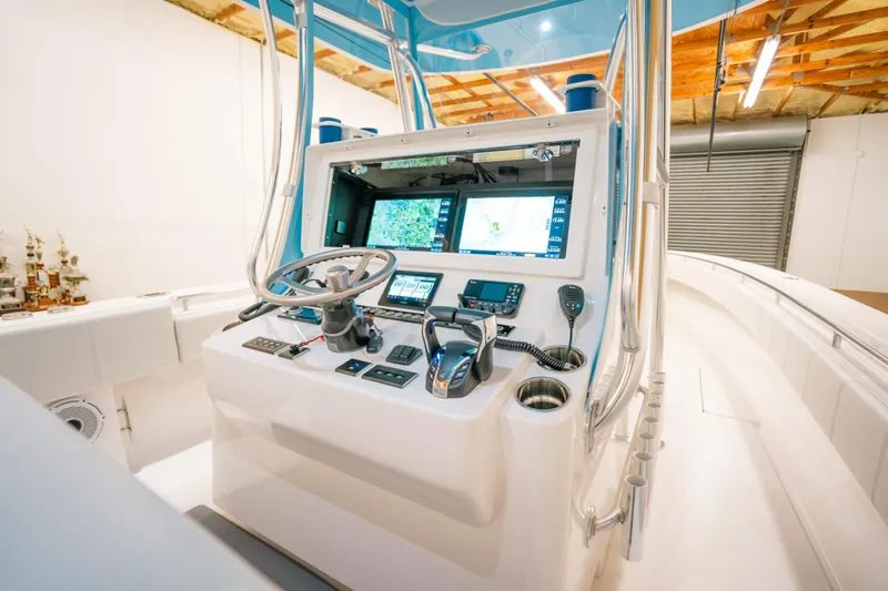 Slide: The Image of 2023 Contender 39 ST boat cockpit with advanced navigation system and controls. - 19