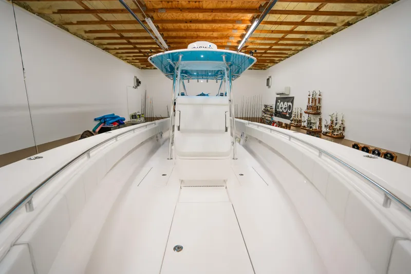 Slide: The Image of 2023 Contender 39 ST boat in a spacious indoor showroom. - 25
