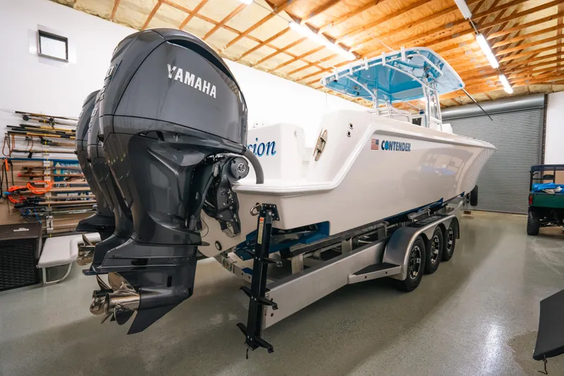 Slide: The Image of 2023 Contender 39 ST boat with Yamaha engines in a garage. - 3