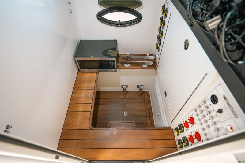 Slide: The Image of 2023 Contender 39 ST boat interior with wood flooring and control panel. - 35